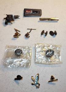 lot 125 image: Mens Jewelry Coors Sports Money Clip, Tie Bars (Pistol & Snap-on Chisel), Tie Tacks, Cuff Links, and Pins (Hesston 1983 & 1984 NFR in Pkg.)