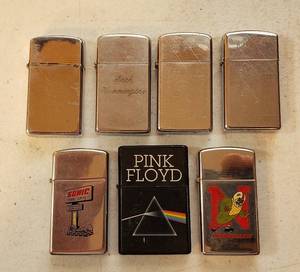 lot 198 image: 7 Vintage Slim Lighters  6 Zippo Sonic, Nebraska Cornhuskers, 4 Chrome and Pink Floyd Lighter