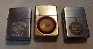 lot 201 image: 3 Vintage Zippo Advertising Lighters  Jim Beam, Phillips 66 and H-30 Drilling Inc.