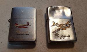 lot 202 image: 2 Vintage Beechcraft Zippo Advertising Lighters  Twin - Bonanza and L-23 US Army