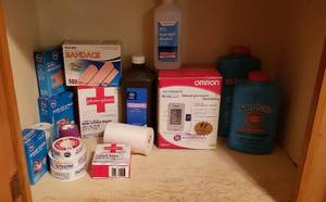lot 256 image: Household Medical Items Blood Pressure Monitor, Bandages, and Foot Powder