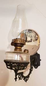 lot 268 image: Vintage Oil Lamp on Cast Iron Wall Sconce wMercury Glass reflective disc  7 x 12 x 17 in. tall