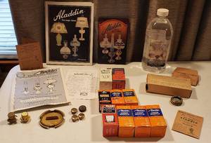 lot 288 image: Aladdin Oil Lamp Accessories Mantles, Wicks, Wick Cleaners, Caps, Books, Electric Converter and New Bottle of Florasense Lamp Oil