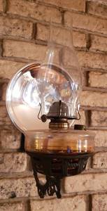 lot 289 image: Vintage Oil Lamp wMercury Glass Disc & Cast Iron Wall Sconce  8 x 12.5 x 16 in. tall