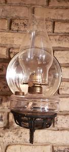lot 290 image: Vintage Oil Lamp wMercury Glass Disc & Cast Iron Wall Sconce  8 x 12.5 x 16 in. tall