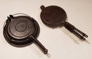 lot 302 image: 2 Cast Iron Waffle Irons Griswold American No. 8 and Wards Cast Iron wHolder