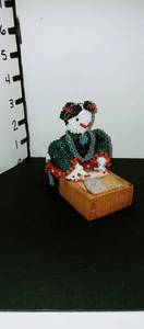 lot 1017 image: Rolanda Booqua hand beaded Native American woman statue