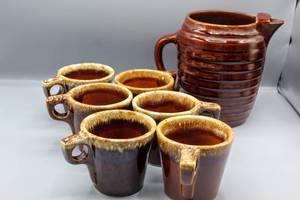 lot 1501 image: (7) Piece Lot Vintage Pottery, Hull Oven Proof Pottery, Brown Drip (6) Mugs and (1) Brown Glaze Pottery Honeycomb Water Pitcher