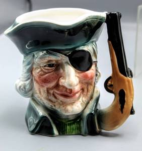 lot 1507 image: Beswick 1116 England Mr. Peggotty Dickens Teapot, Lujenes Japan Pirate Figural Character Mug & Figural Red Coat Soldier Character Cream and Sugar