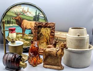 lot 1517 image: Lg Lot Full of Treasures - VintageAntique Apollo Shave Stand with Milk Glass Cup, James L. Artig Metal Art Serving Tray Elk Scene, (2) Antique Crocks, Avon Bottles, Beautiful Carved Wood Frame and more
