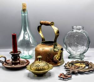 lot 1540 image: Unique Vintage Finds  1949 JZH Cast Iron Trivet, Pottery Candle Holder, Ornate Brass Dish, Copper Brass Kettle, Italian Vino Bottle, Glass Clock Bottle