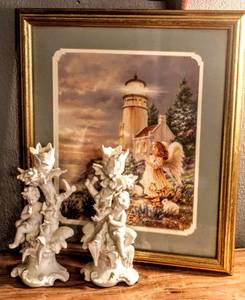 lot 1571 image: Beautifully Framed Double Matted Print of Young Angel Near Lighthouse and (2) Bisque Cherub Candlesticks marked 6342