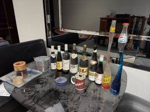 lot 7290 image: Contents on Table - 2 Elongated Pop Bottles, Wine Bottles and Small Budweiser Bucket