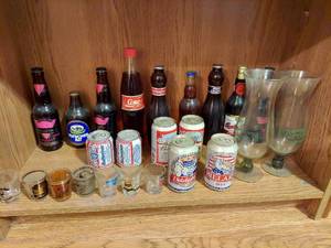 lot 7348 image: Bottles, Cans and Shotglasses on Bottom Shelf