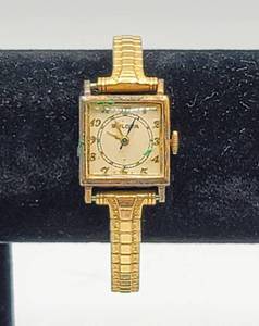 lot 7015 image: Vintage Womens Bulova Watch 10K GF Top Caps, Engraved with date 51044 - Speidel stretch wrist band.