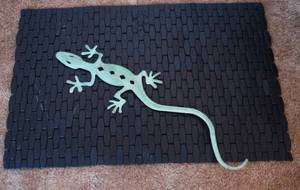 lot 5217 image: Black Wooden Floor Mat and Lizard Metal Art