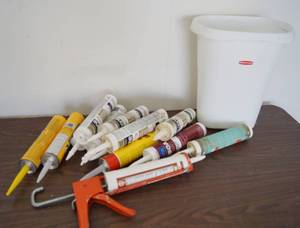 lot 5236 image: Lot of Various Caulking (all tubes new and still soft) w Caulking Gun and trash can - SEE PICS