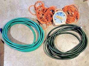 lot 8061 image: (2) Nice Garden Hoses, (2) Orange Extension Cords  Extension Cord Reel with Outlets