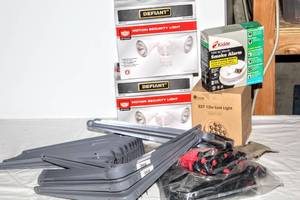 lot 8036 image: Assorted Lot of Items (20) Shelf Brackets  10 x 12 Grey, (2) Defiant Motion Security Lights,  Kidde Front Loading Battery Smoke Alarm, E27 12w LED Light, Tarp canopy Bungee Cords,  (6) Wall Brackets